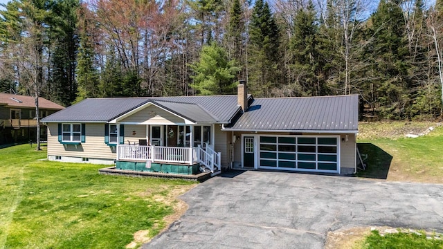 15 Garys Dr, Littleton, NH 03561 - view of front facade with an attached garage, covered porch, driveway, and a front yard