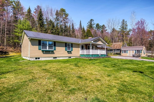 15 Garys Dr, Littleton, NH 03561 - view of front of property with covered porch, a front lawn, metal roof, and an outdoor structure