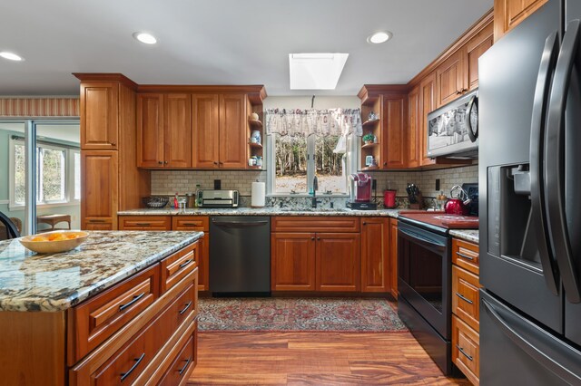 15 Garys Dr, Littleton, NH 03561 - kitchen featuring black fridge, dishwashing machine, a sink, stainless steel microwave, and electric stove
