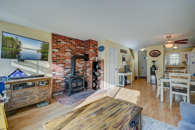 45 Haynesville Ave Unit 3, Conway, NH 03818 - living area featuring a wood stove, light wood finished floors, and a ceiling fan