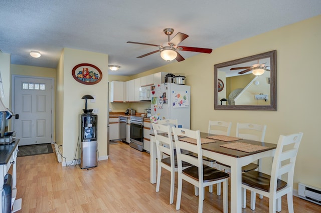 45 Haynesville Ave Unit 3, Conway, NH 03818 - dining room featuring a baseboard radiator, ceiling fan, and light wood finished floors