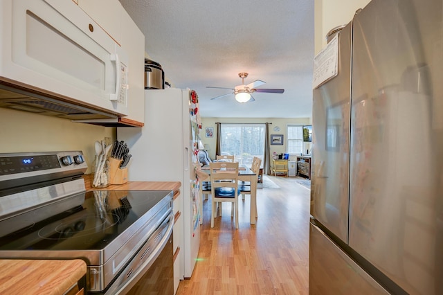 45 Haynesville Ave Unit 3, Conway, NH 03818 - kitchen featuring stainless steel appliances, light wood finished floors, white cabinets, and ceiling fan