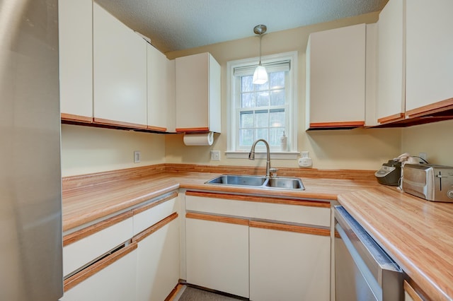 45 Haynesville Ave Unit 3, Conway, NH 03818 - kitchen with a sink, dishwasher, white cabinetry, pendant lighting, and a textured ceiling