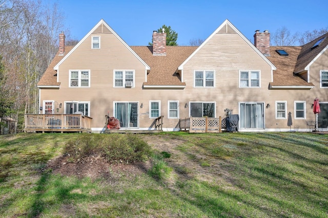 45 Haynesville Ave Unit 3, Conway, NH 03818 - back of property with a chimney, a lawn, a wooden deck, and a shingled roof