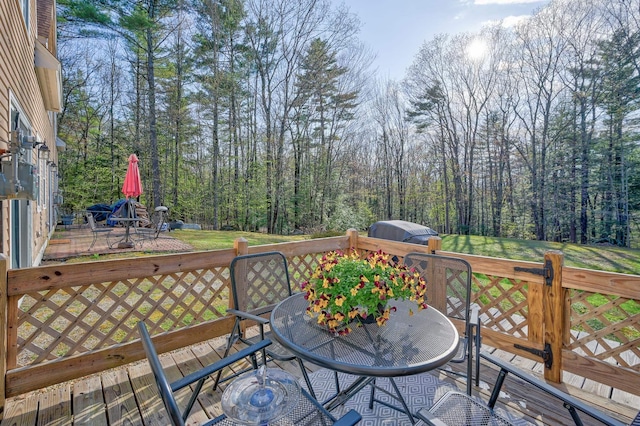 45 Haynesville Ave Unit 3, Conway, NH 03818 - wooden deck with outdoor dining area and a forest view
