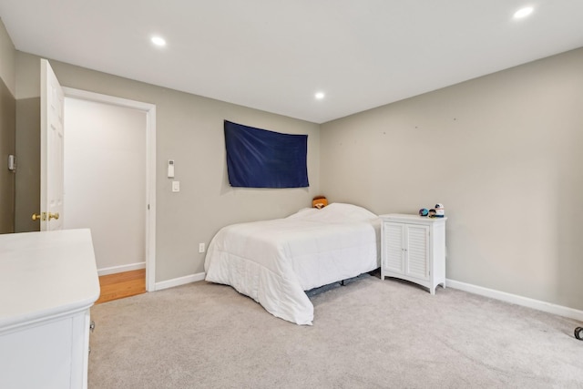 bedroom with light carpet, recessed lighting, and baseboards