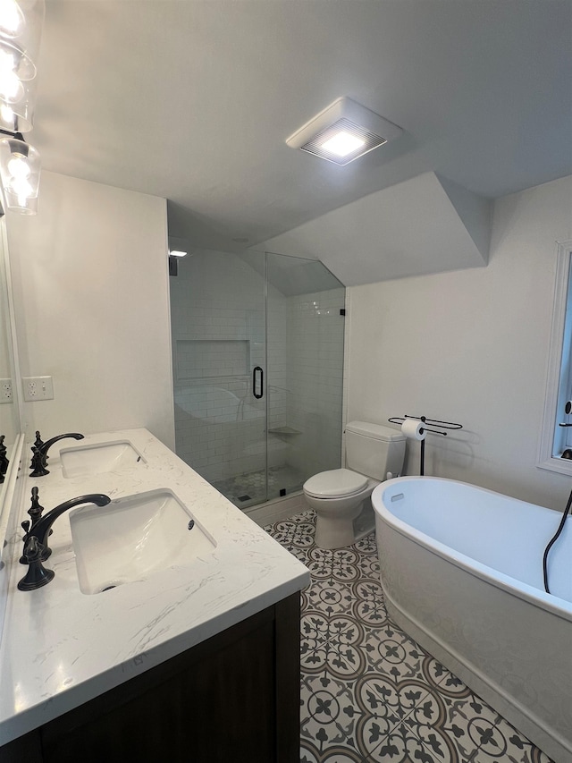 bathroom featuring a soaking tub, a stall shower, double vanity, toilet, and tile patterned floors