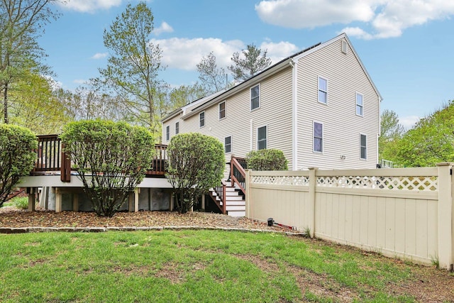 back of property featuring a deck and stairs