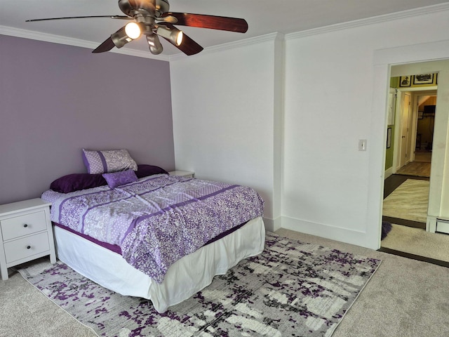 carpeted bedroom with ornamental molding and a ceiling fan