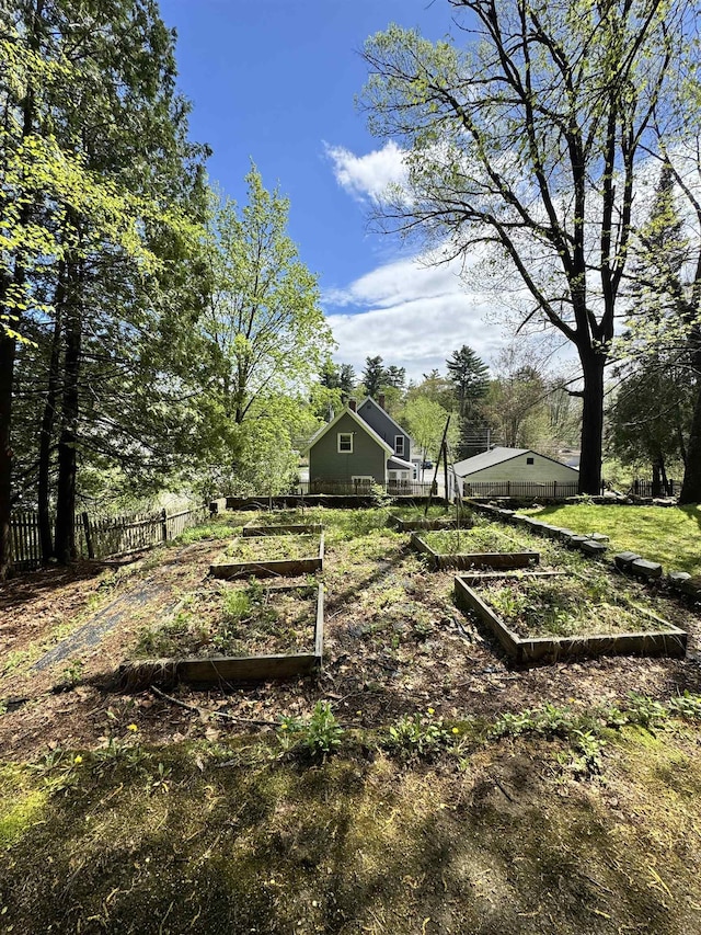 view of yard featuring a vegetable garden and fence