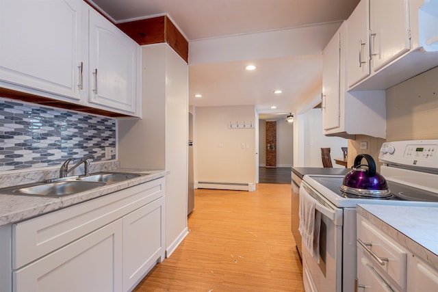 kitchen featuring white range with electric stovetop, a sink, a baseboard radiator, white cabinets, and recessed lighting