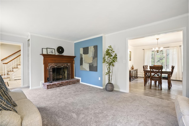 15 Roosevelt Dr, Bedford, NH 03110 - living area with carpet floors, crown molding, a chandelier, a brick fireplace, and baseboards