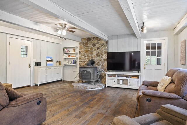 15 Roosevelt Dr, Bedford, NH 03110 - living area featuring a wood stove, hardwood / wood-style floors, healthy amount of natural light, ceiling fan, and beam ceiling