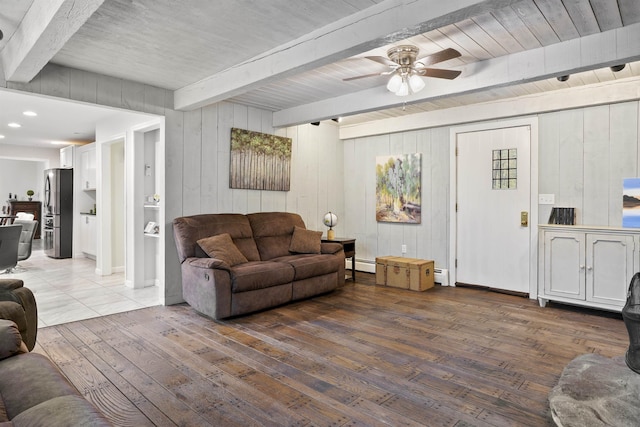 15 Roosevelt Dr, Bedford, NH 03110 - living room featuring beamed ceiling, hardwood / wood-style flooring, a baseboard heating unit, ceiling fan, and wood walls