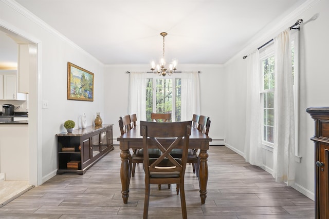 15 Roosevelt Dr, Bedford, NH 03110 - dining room with a chandelier, wood finished floors, crown molding, baseboard heating, and baseboards