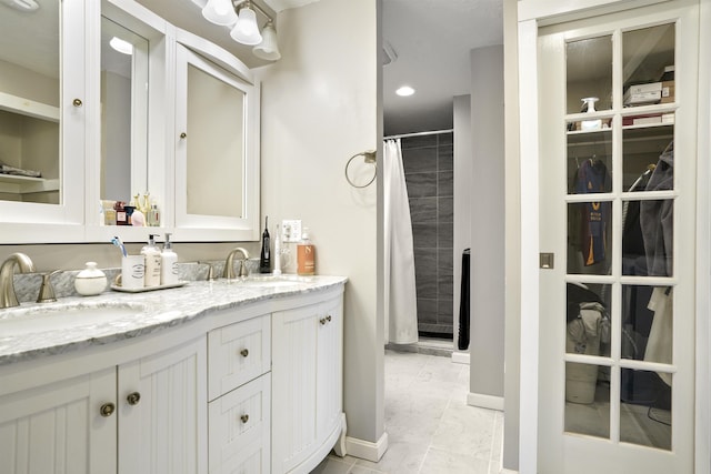 15 Roosevelt Dr, Bedford, NH 03110 - full bath featuring double vanity, baseboards, curtained shower, marble look tile flooring, and recessed lighting