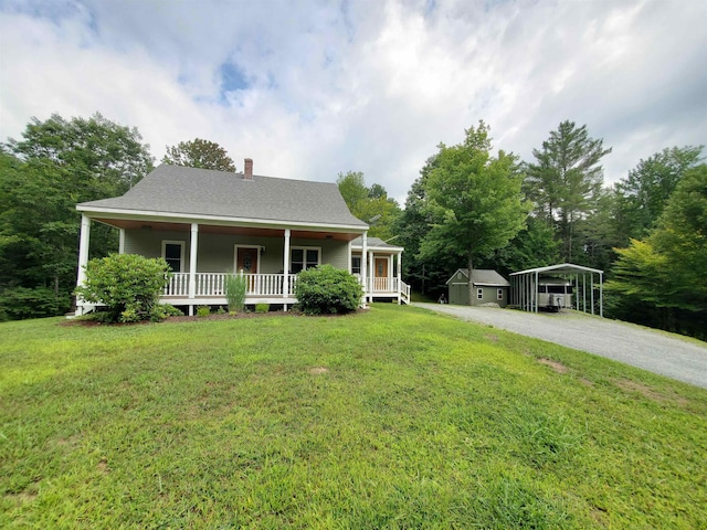 farmhouse inspired home with a porch, a carport, a front yard, and a chimney