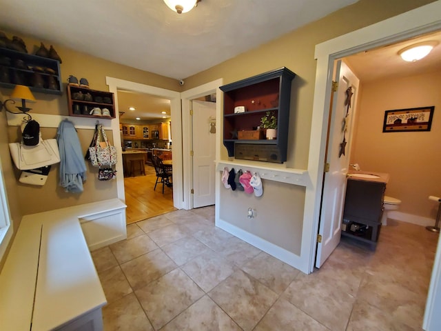 interior space with light tile patterned floors and a sink