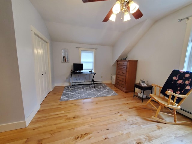 office space with vaulted ceiling, a ceiling fan, wood finished floors, and baseboards