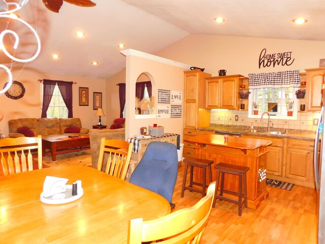 dining area with lofted ceiling, plenty of natural light, light wood finished floors, and recessed lighting