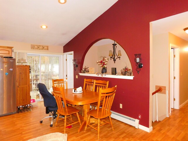 dining space with a baseboard radiator, light wood-type flooring, lofted ceiling, baseboards, and recessed lighting