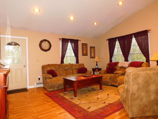 living area featuring light wood-style flooring, recessed lighting, a baseboard heating unit, baseboards, and vaulted ceiling