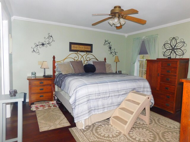 bedroom with wood finished floors, ornamental molding, and ceiling fan