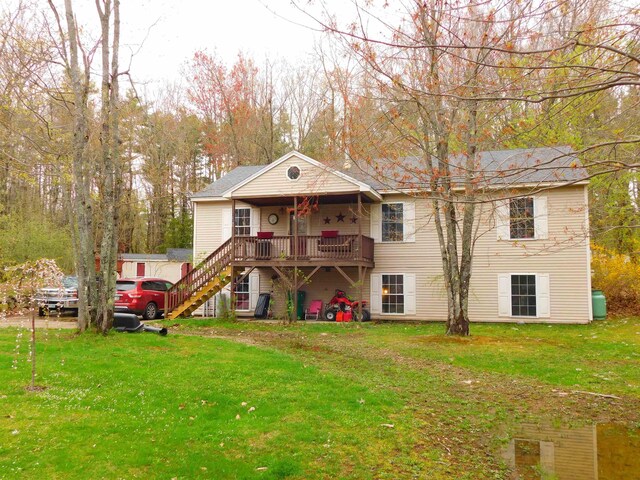 back of property with stairway and a yard
