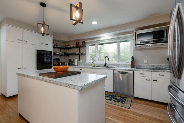 113 Watchtower Rd, Hopkinton, NH 03229 - kitchen featuring stainless steel appliances, a sink, light wood-style flooring, a center island, and white cabinets