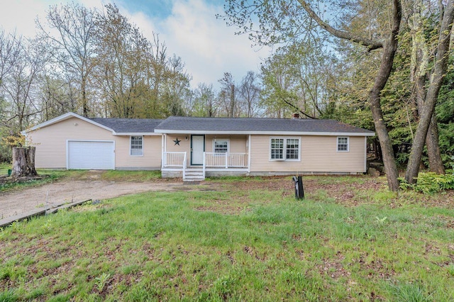 single story home featuring a porch, dirt driveway, and an attached garage