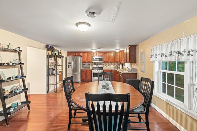 dining area featuring baseboards and wood finished floors