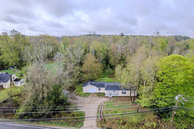 view of subject property featuring a forest