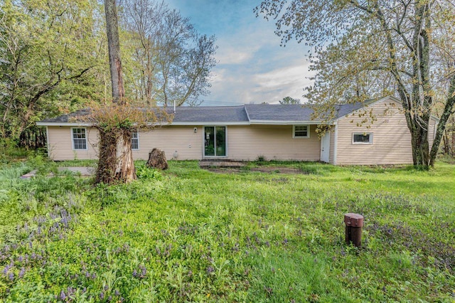 rear view of house with a yard