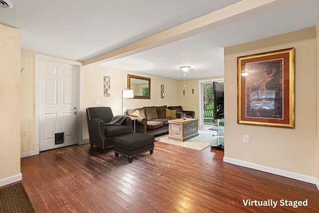 living area with wood-type flooring and baseboards