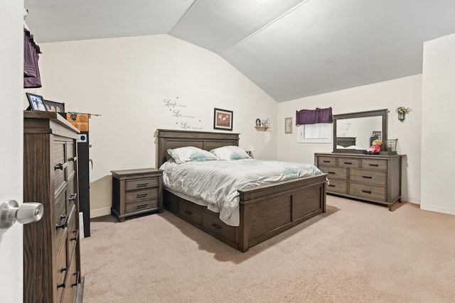 bedroom with vaulted ceiling, light colored carpet, and baseboards
