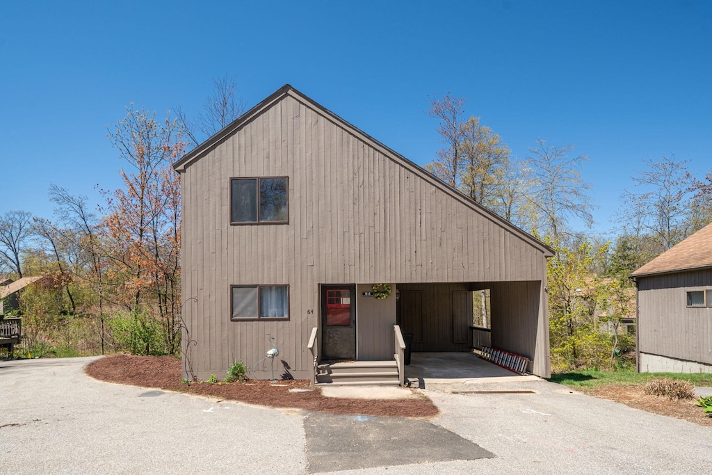 64 Coburn Woods Ave Unit 64, Nashua, NH 03063 - view of front of house featuring asphalt driveway and a carport