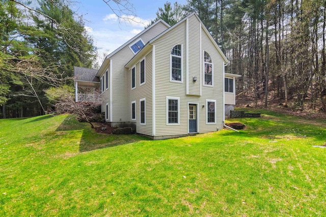back of property featuring a lawn