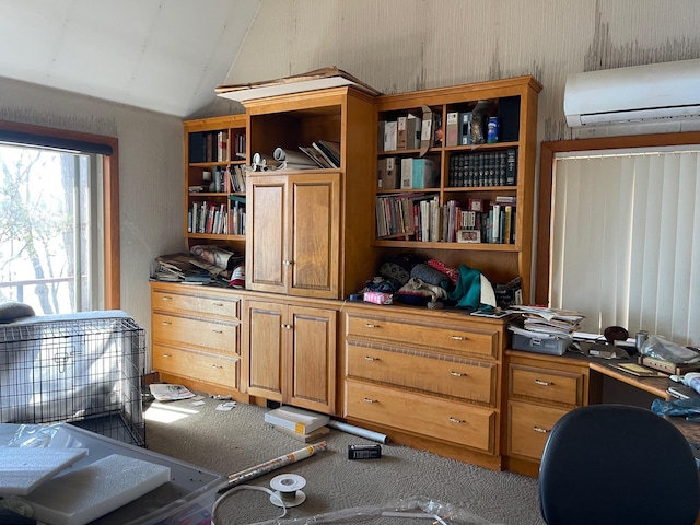 home office featuring vaulted ceiling, an AC wall unit, and carpet flooring