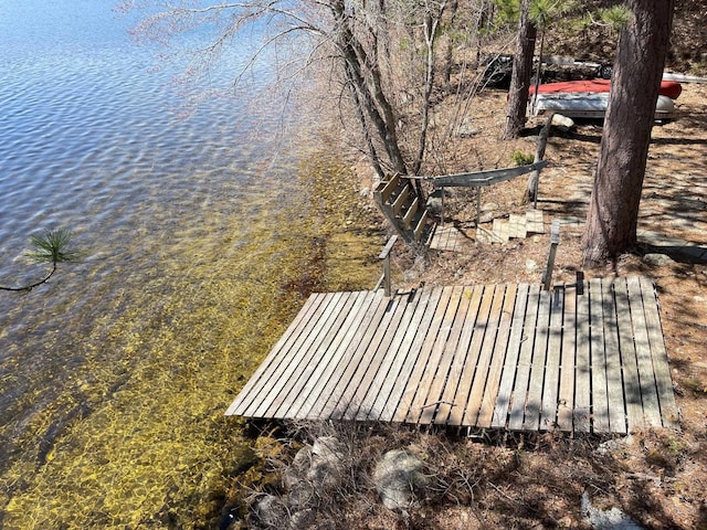 wooden terrace featuring a water view