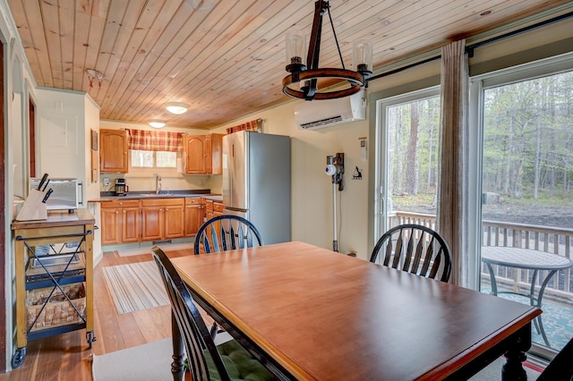 dining room with a wall mounted air conditioner, wood ceiling, and light wood-style flooring