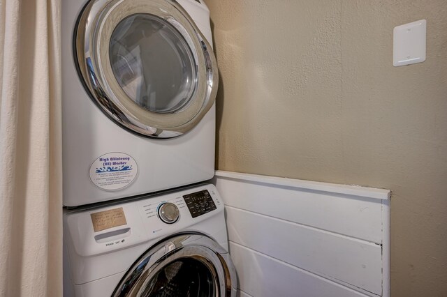 laundry room with stacked washing machine and dryer