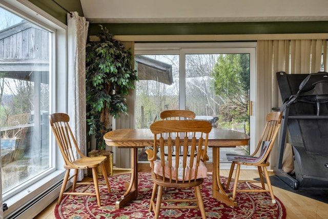 331 Gilman Rd, Sheldon, VT 05450 - dining space featuring a baseboard heating unit, healthy amount of natural light, and light wood-style flooring