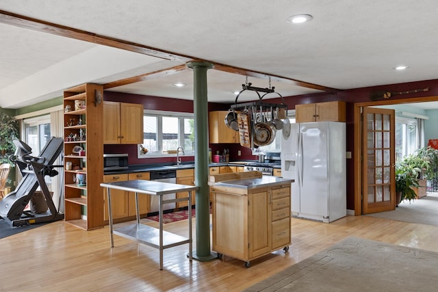331 Gilman Rd, Sheldon, VT 05450 - kitchen featuring stainless steel appliances, a sink, light wood finished floors, plenty of natural light, and a textured ceiling
