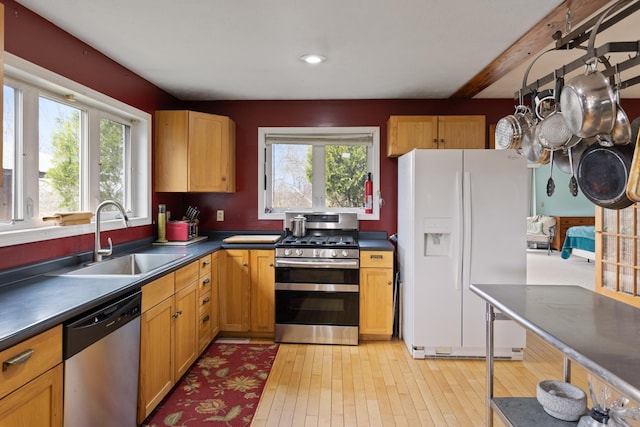 331 Gilman Rd, Sheldon, VT 05450 - kitchen featuring appliances with stainless steel finishes, a sink, plenty of natural light, dark countertops, and beam ceiling