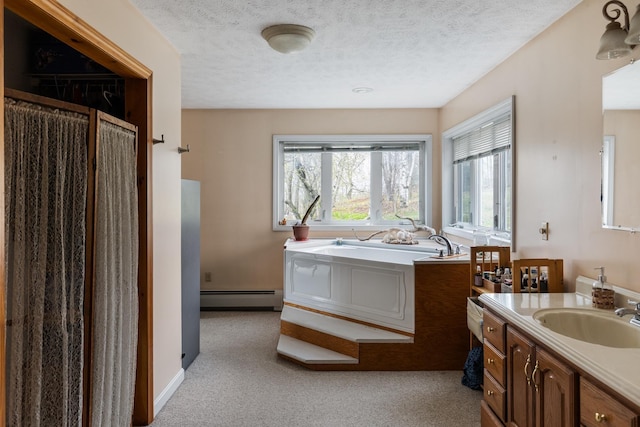 331 Gilman Rd, Sheldon, VT 05450 - bathroom with baseboard heating, a bath, vanity, and a textured ceiling