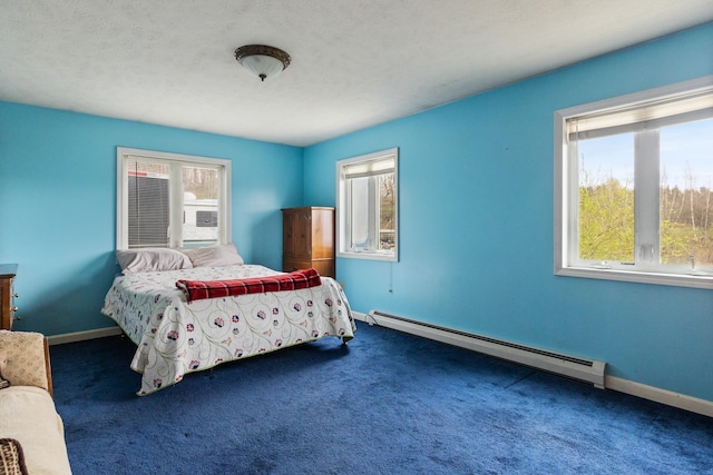 331 Gilman Rd, Sheldon, VT 05450 - bedroom featuring a baseboard radiator, multiple windows, dark carpet, and baseboards