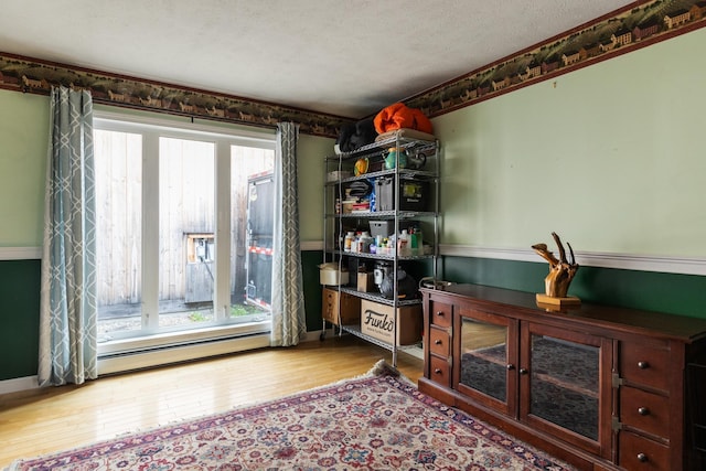 331 Gilman Rd, Sheldon, VT 05450 - office area with a baseboard radiator, hardwood / wood-style flooring, a textured ceiling, and baseboards