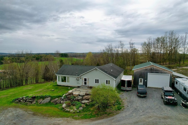 331 Gilman Rd, Sheldon, VT 05450 - view of front facade with a garage, dirt driveway, and an outdoor structure