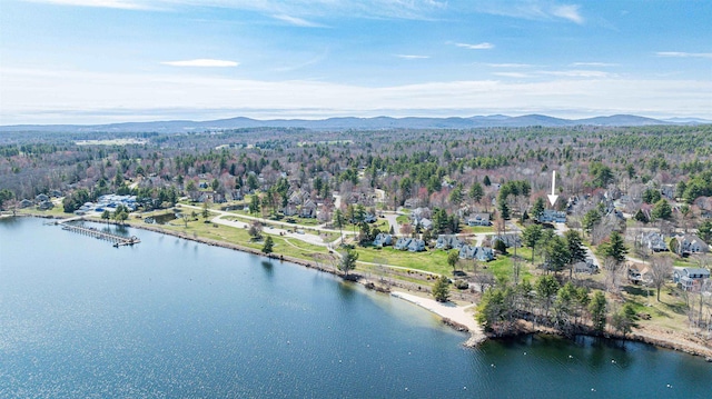 aerial view of property's location with a water and mountain view and a heavily wooded area