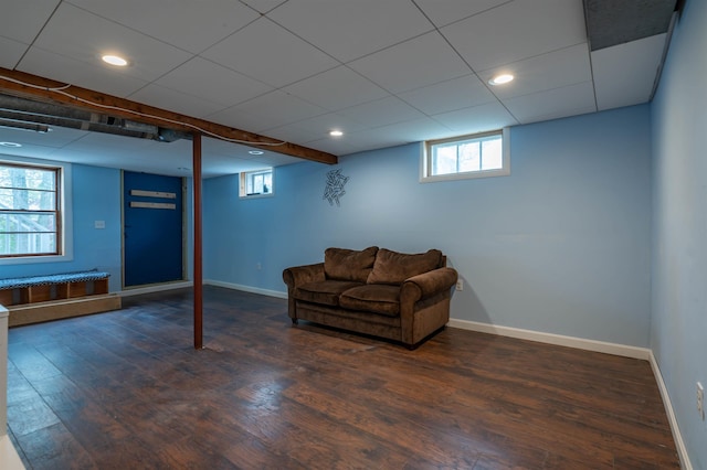 basement with wood finished floors, baseboards, recessed lighting, and a drop ceiling